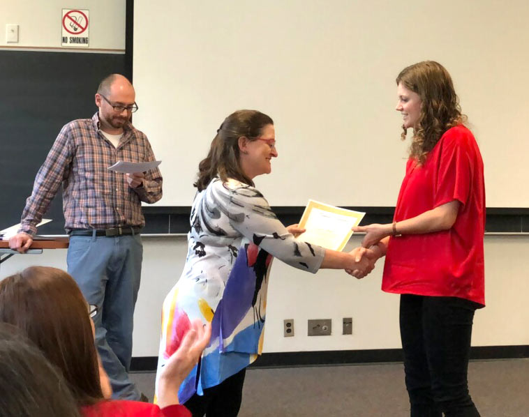 Dr. Todd Smitherman (left). Dr. Rebekah Smith (middle) hands Sarah Berry an award.