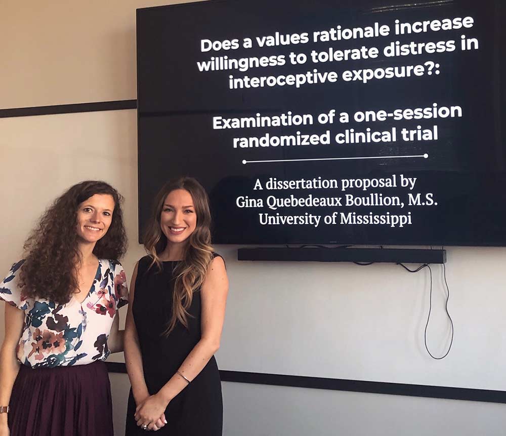 Dr. Laura Dixon (left) and Gina Boullion in front of her thesis presentation display.